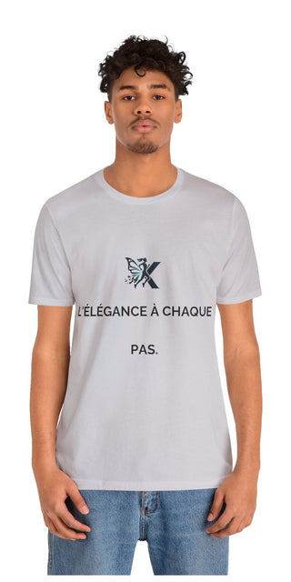 Gray unisex jersey short sleeve t-shirt with text graphic featuring the letter "X" and the French phrase "L'elegance a chaque pas" (Elegance with every step).