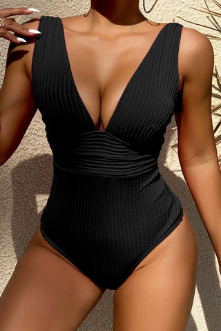 Sophisticated black one-piece swimsuit with flattering pleated design and wide straps