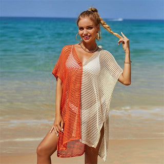 Colorful beach cover-up with V-neck, knit texture, and two-tone design. Sleeveless and flowing over a swimsuit on a sandy beach with turquoise ocean in the background.