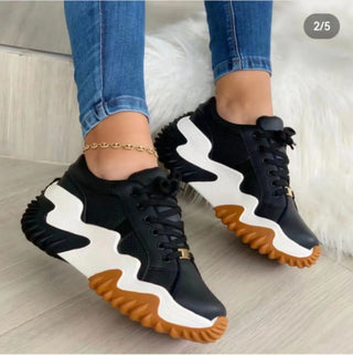 Women's Lightweight Breathable Sneakers by Hypersku - Stylish black and white athletic shoes with vibrant orange soles on a white background.