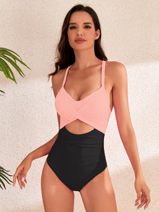 Stylish cross-front swimsuit with high-waisted bottoms and tropical greenery