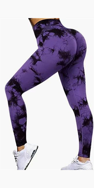 Fashionable tie-dye printed leggings in vibrant purple hue, featuring a high-waist design and tight, form-fitting silhouette for a flattering, athletic look. Suitable for various fitness activities and casual wear.
