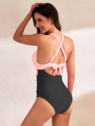 Stylish neon pink cutout swimsuit with waist tie and low back detail