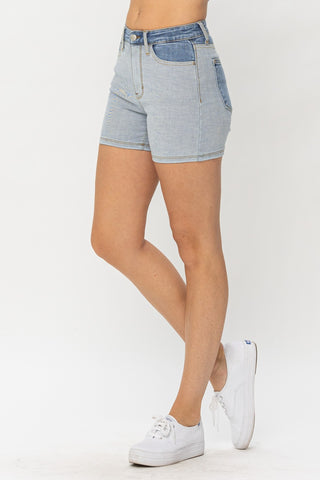Fashionable stretch denim shorts in a modern heather grey tone, showcasing a stylish and comfortable design for the contemporary woman.