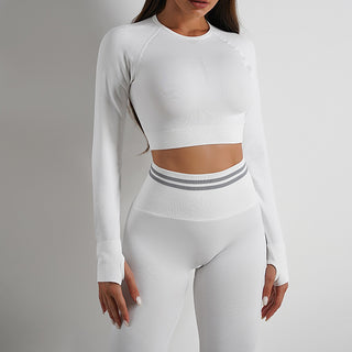 Sleek white knit yoga outfit with long-sleeved crop top and high-waisted leggings, showcasing sporty yet stylish design.