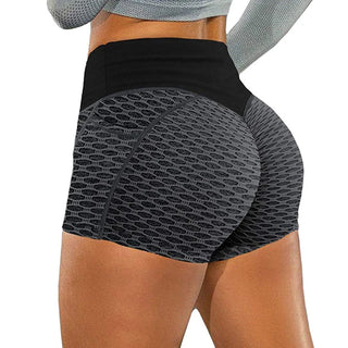 Breathable women's yoga shorts with textured pattern. Figure-flattering athletic bottoms in dark color for gym, jogging or fitness activities. Sleek, skinny design with stretchy, lightweight material for a comfortable workout.