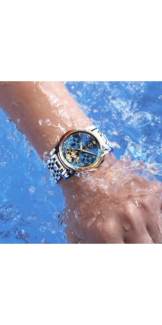 Elegant men's automatic watch with skeleton dial and moonphase, displayed on a wrist against a backdrop of blue water, showcasing its waterproof design and stylish, functional features.
