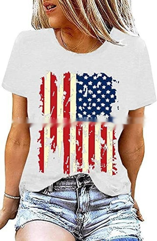 Stylish American flag graphic printed white t-shirt on a female model with casual denim shorts and blonde hair