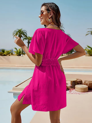 Vibrant fuchsia off-shoulder mini dress with relaxed silhouette and smocked waist, perfect for a chic poolside getaway.