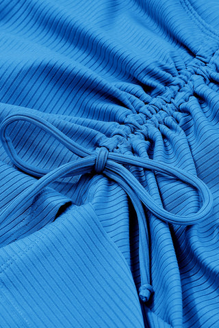 Textured blue fabric with pleated design and drawstring waist
