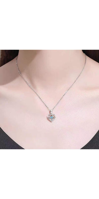 Elegant heart-shaped necklace with sparkling rhinestones, elegant women's fashion accessory displayed on model's neck.