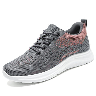 Comfortable, lightweight sneakers for women. Breathable mesh upper with lace-up closure. Stylish color-block design in shades of gray and coral. Ideal for daily casual wear or light activity. Durable, flexible sole provides good traction and cushioning.