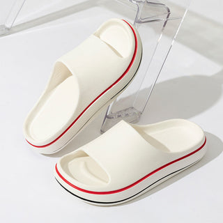 Stylish men's slippers with a sleek, modern design and comfortable platform. The cream-colored uppers feature bold red accents, creating a striking and trendy look. These versatile slippers are perfect for lounging at home or stepping out in style.