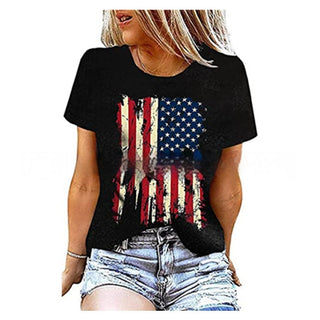 Stylish black t-shirt with American flag graphic design, worn by a young blond woman with relaxed casual outfit.