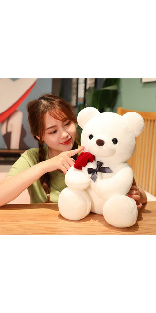Soft white bear plush toy with red rose, held by young woman in casual outfit
