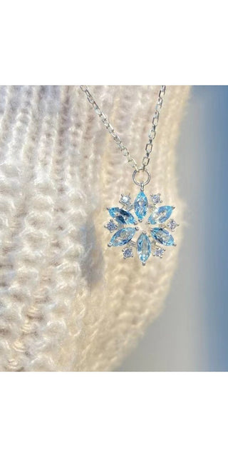 Sparkling snowflake pendant necklace adorned with shimmering rhinestones, a stylish accessory to elevate any winter outfit.
