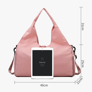 Pink and sleek sports bag with dry and wet separation, large storage capacity, and ample space to carry a yoga mat and other fitness essentials.
