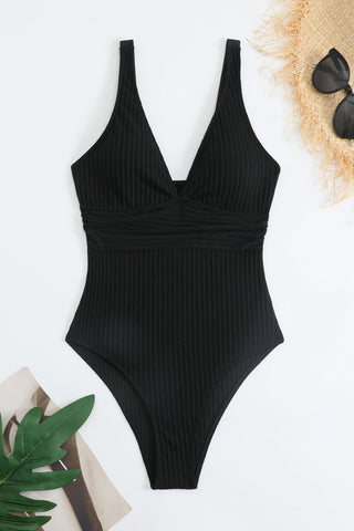 Black ribbed one-piece swimsuit with wide straps and plunging neckline