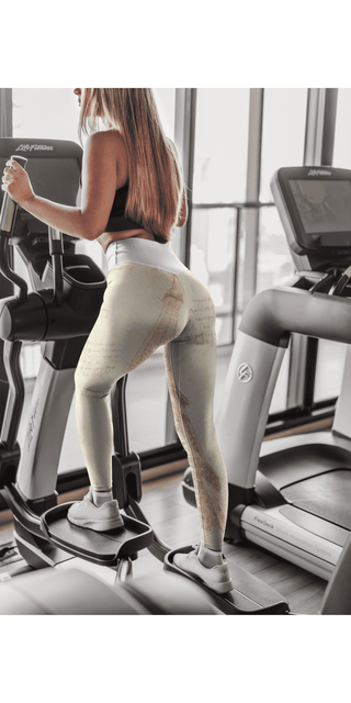 Stylish women's leggings with unique design and pockets, worn by a woman working out on a treadmill in a fitness studio.