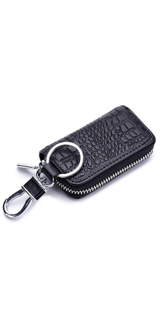 Compact leather key holder with zipper closure, featuring a stylish croc-embossed pattern. Ideal for organizing and protecting your car keys while on the go.