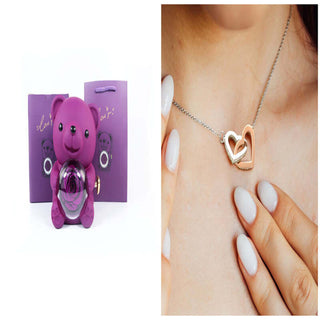 Rotating Eternal Flower Ring Necklace Packaging Box - Elegant heart-shaped pendant necklace with delicate silver chain presented in a vibrant purple gift box.