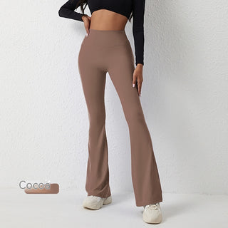 High-waist flared yoga pants in neutral cocoa color, worn by a woman in a black top, showcasing a sleek and stylish athleisure look.