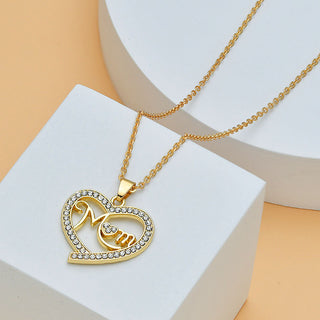 Gold-toned Mom Heart Shape with Diamond Letter Necklace
Elegant, sparkling heart-shaped pendant necklace with diamond-encrusted "Mom" lettering, showcased on a delicate gold chain.