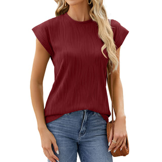 Stylish crimson red pleated top worn by a woman against a plain white background.