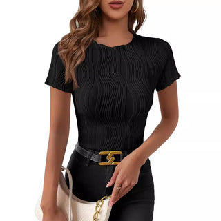 Elegant black pleated top with short sleeves worn by a stylish young woman