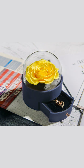 Elegant yellow rose in glass dome on trendy fashion magazines, stylish jewelry accessory for Valentine's Day or birthday gift