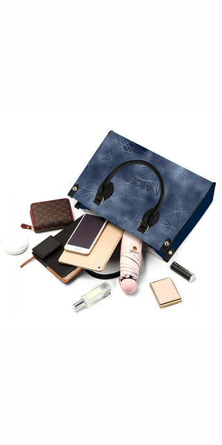 Stylish women's accessories from K-AROLE: navy blue leather tote bag, cosmetics, and fashion accessories elegantly arranged on a white background.