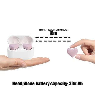 Cute heart-shaped wireless Bluetooth earphones with noise reduction and 30mAh battery capacity, positioned on a hand within 10m transmission distance.