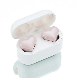 Cute and fashionable heart-shaped wireless Bluetooth earphones in a stylish white charging case. These trendy in-ear headphones with noise reduction feature a fun and modern design, perfect as a gift for a woman.