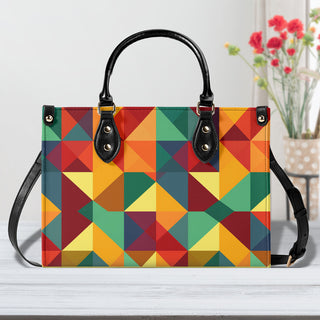 Vibrant Geometric Tote Bag - Colorful, patterned handbag with a structured design and sleek black handles, showcasing a striking geometric print in hues of red, green, yellow, and orange.