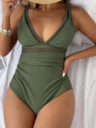 One-piece olive green swimwear with plunge neckline and mesh panels, perfect for a stylish beach look.