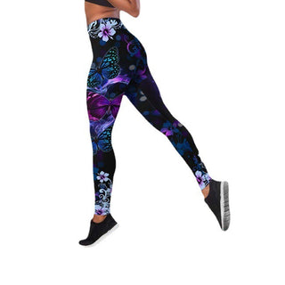Vibrant butterfly and floral printed high-waist yoga pants in a sleek athletic style, showcasing the model's active wear.