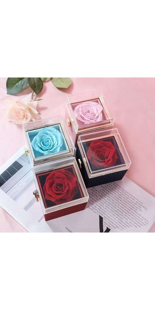 Elegant rose-themed jewelry boxes on pink background. Assorted color preserved roses showcased in stylish display cases. Romantic, luxurious proposal or anniversary gift.