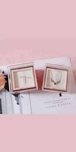 Elegant diamond jewelry displayed in minimalist white frames on a pink background at K-AROLE, the premier women's fashion and accessory destination.