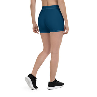 Stylish blue athletic shorts showcasing a woman's toned figure and legs. The shorts appear to be made of a stretchy, breathable material, suitable for active wear or casual wear. The image focuses on the lower body and legs, highlighting the comfortable and trendy design of the K-AROLE brand shorts.