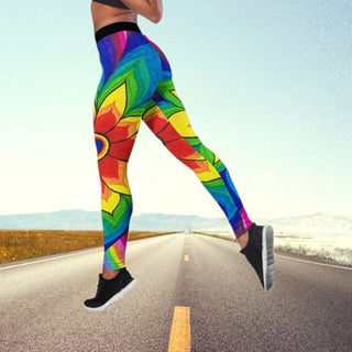 Vibrant butterfly-print yoga pants on a person walking on an open road with mountains in the background.