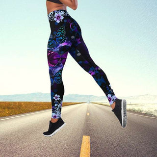 Colorful floral and butterfly print yoga pants on model standing on road