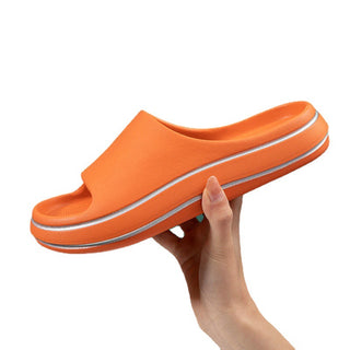 Trendy orange slippers for men with white stripes, suitable for comfortable home or casual outdoor wear.