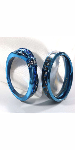 Stunning matching blue titanium rings with intricate floral patterning, perfect for a stylish couple's wedding or anniversary.