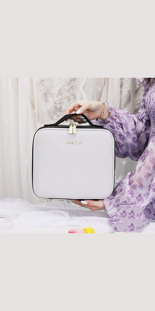 Chic white cosmetic bag with LED lights and mirrored interior, perfect for on-the-go beauty touch-ups.