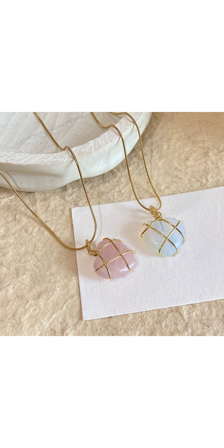 Delicate Moonstone Pendant Necklaces
Elegant moonstone and quartz crystal pendant necklaces showcased on a soft, minimalist background at the K-AROLE jewelry store. These trendy, eye-catching pieces add a touch of whimsy and enchantment to any outfit.