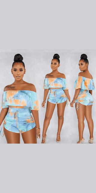 Stylish Tie-Dye Jumpsuit: Vibrant off-shoulder design, trendy shorts, and chic high-bun hairstyles showcased on models against a plain background.