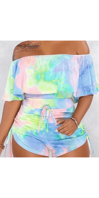 Vibrant Tie-Dye Crop Top and Shorts Set
This image shows a fashionable two-piece outfit in a vibrant tie-dye pattern. The set includes a cropped off-the-shoulder top and matching high-waisted shorts, creating a stylish and trendy look.
