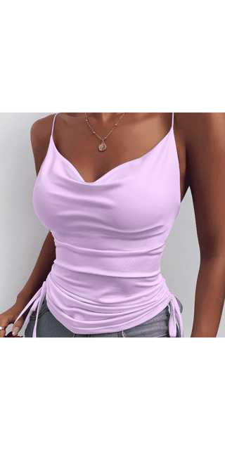 Spaghetti strap camisole in pale pink color with adjustable back and matching pendant necklace on woman's torso.