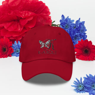 Vibrant red and blue floral arrangement with a red K-AROLE branded dad hat in the center, featuring an embroidered butterfly logo.