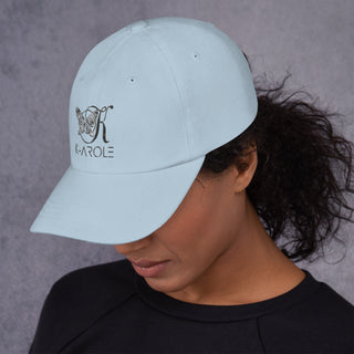 Stylish K-AROLE branded dad hat worn by a model with dark, curly hair.